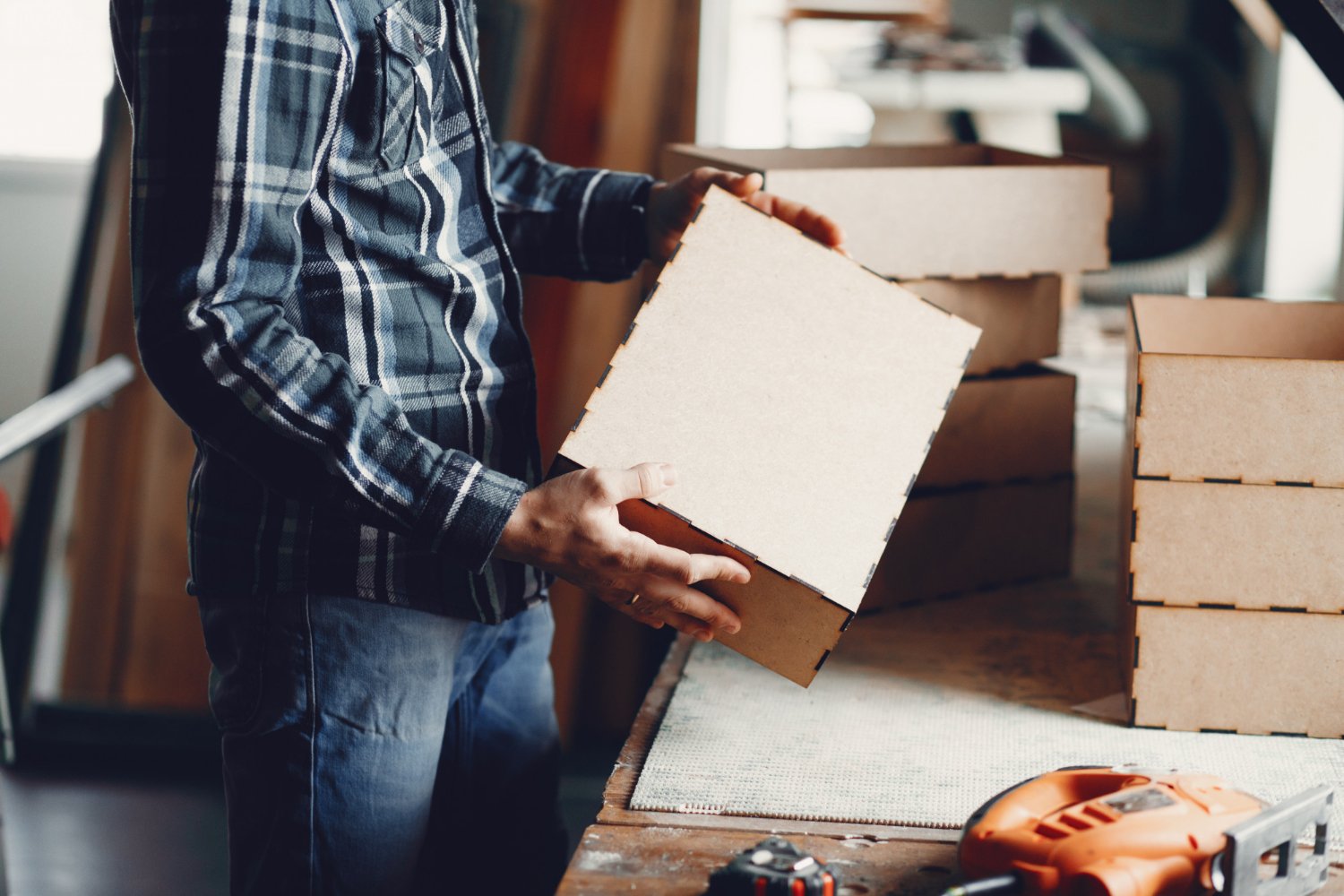 Craftsman assembling a packaging box by hand