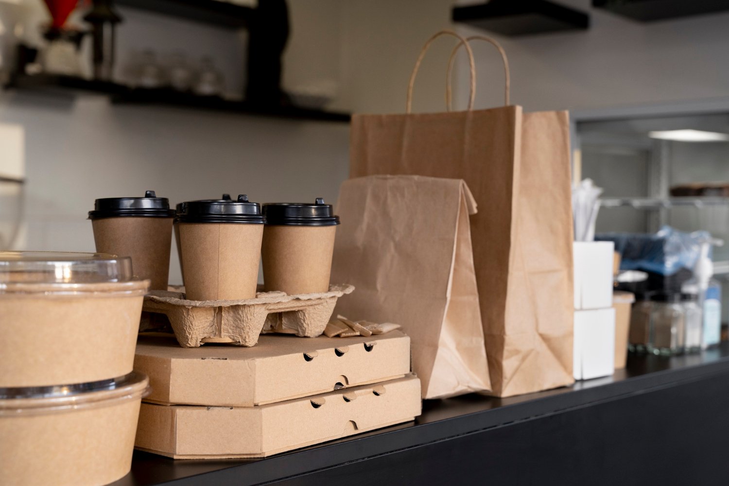 Coffee cups and takeout bags on a cafe counter